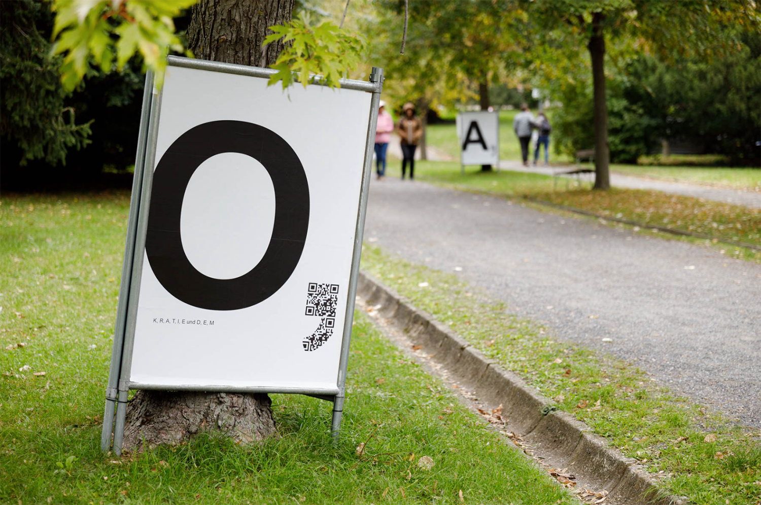 Wir Hier with God’s Entertainment ‚D, E, M, O, K, R, A, T, I und E‘ (installation view Otto Wagner Areal) 2025.