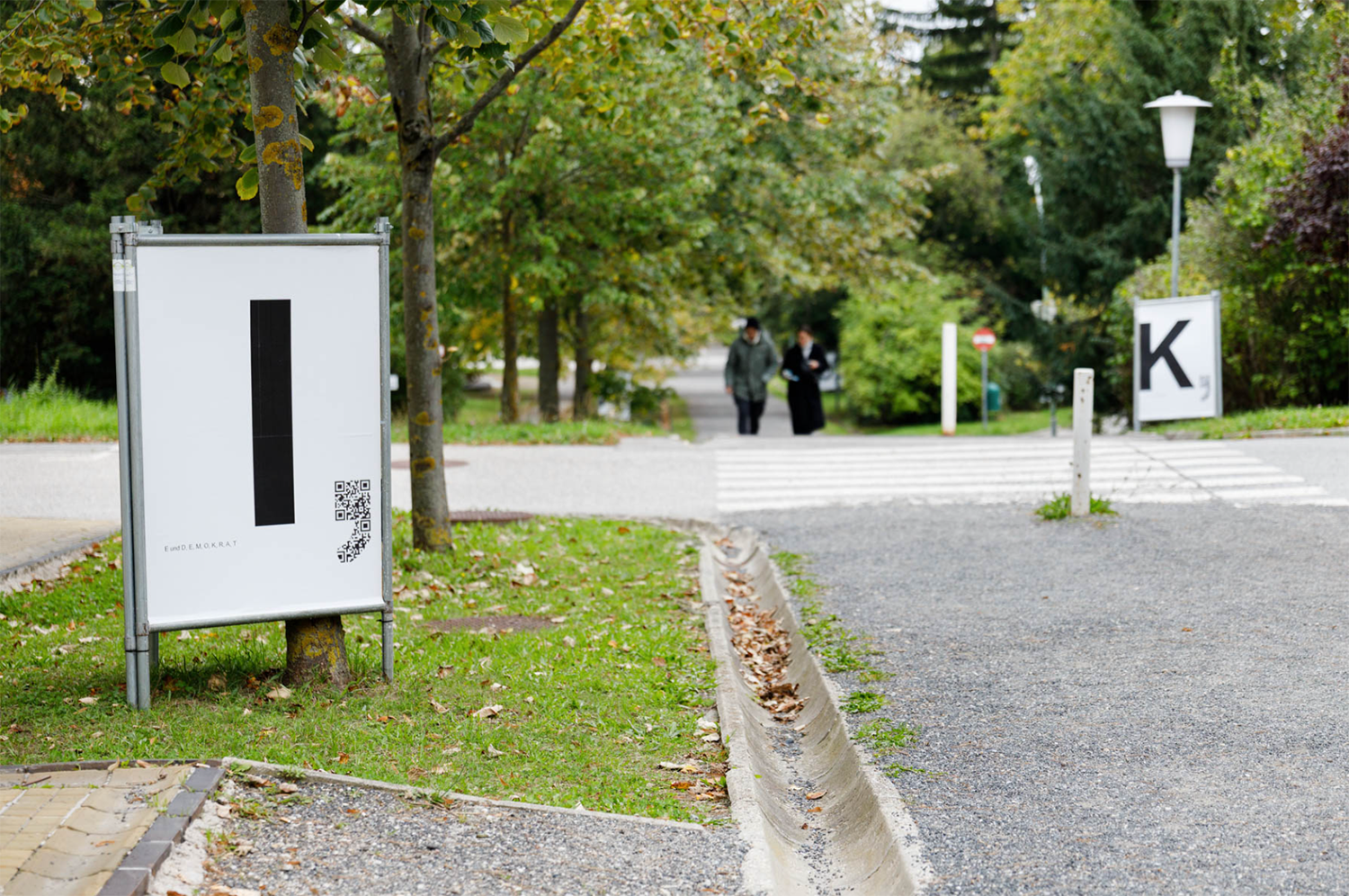 Wir Hier with God’s Entertainment ‚D, E, M, O, K, R, A, T, I und E‘ (installation view Otto Wagner Areal) 2025.